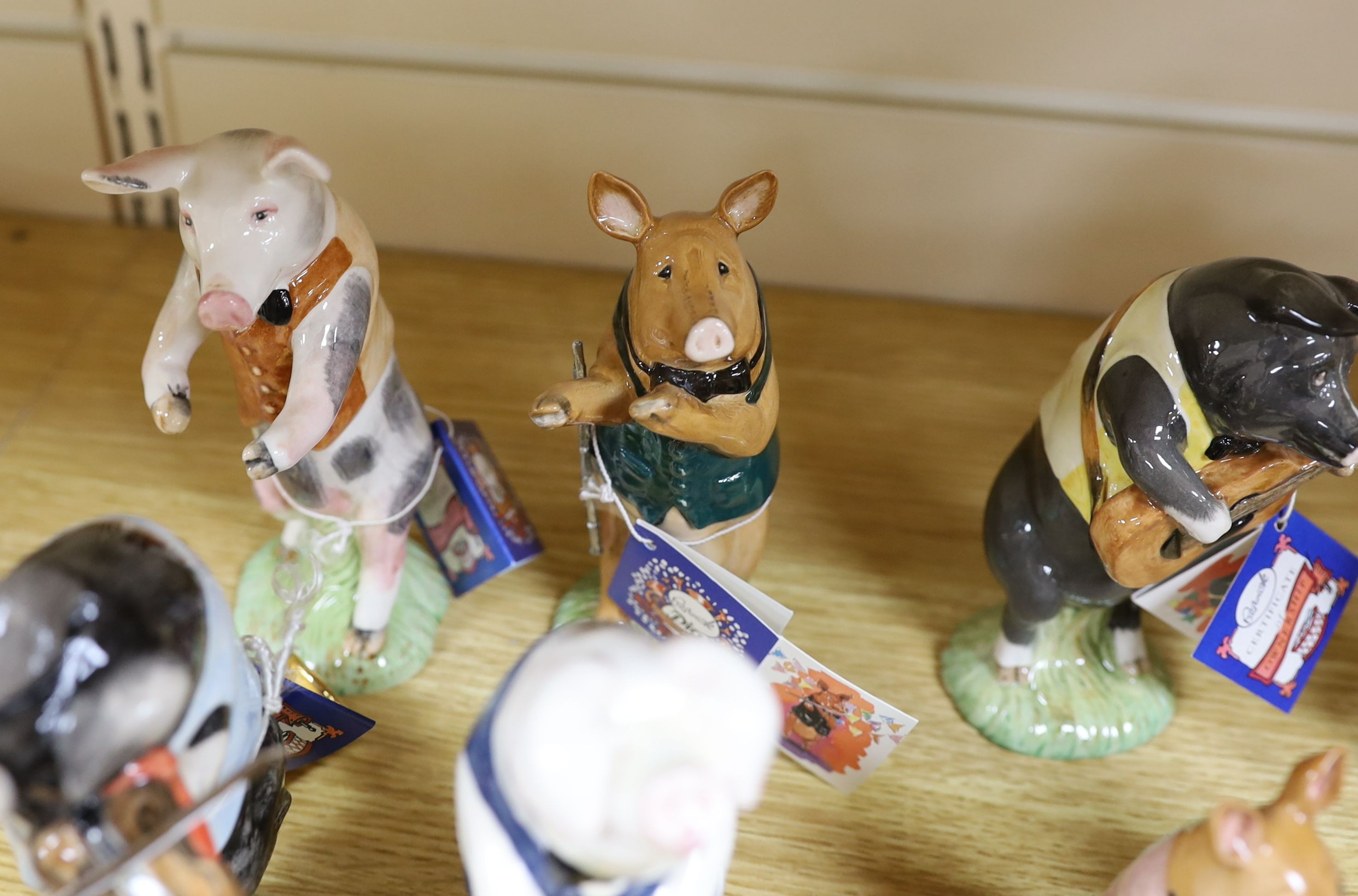 Eighteen Beswick figures, to include the Pig Promenade (10), and English Country Folk (8)